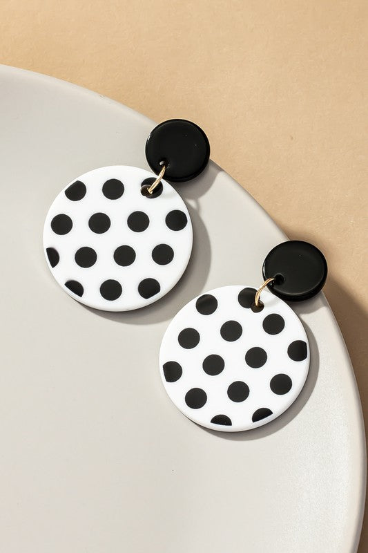 white earrings with black polka dots